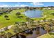 Community aerial view showing homes, golf course, and lake at 10055 Links Ln # 206, Rotonda West, FL 33947