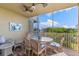 Screened lanai with patio furniture and golf course view at 10055 Links Ln # 206, Rotonda West, FL 33947
