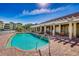 Resort-style pool with brick patio and comfortable seating at 10055 Links Ln # 206, Rotonda West, FL 33947