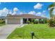 Single-story home with two-car garage and lush lawn at 2555 Dixon Ter, Port Charlotte, FL 33981