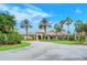 Community clubhouse with palm trees and landscaped grounds at 1337 Sorrell Way, North Port, FL 34289