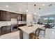 Modern kitchen with dark cabinets, quartz countertops, and island at 1337 Sorrell Way, North Port, FL 34289