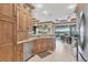 Bright kitchen featuring wood cabinetry, granite countertops, and an open design with serene water views at 15172 Leipzig Cir, Port Charlotte, FL 33981