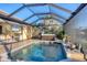 Outdoor pool and patio featuring a grill and hot tub and a tropical outdoor view at 15172 Leipzig Cir, Port Charlotte, FL 33981