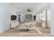Bright living room features neutral decor, a TV, and ample natural light at 20 Annapolis Ln, Rotonda West, FL 33947