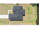 Aerial view of home, showing roof and surrounding yard with water view at 220 Mark Twain Ln, Rotonda West, FL 33947