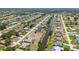 An aerial view of a residential neighborhood featuring waterfront properties with access to a winding canal at 220 Mark Twain Ln, Rotonda West, FL 33947