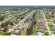 An aerial view of a residential neighborhood featuring waterfront properties with access to a winding canal at 220 Mark Twain Ln, Rotonda West, FL 33947
