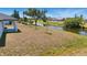 A spacious backyard featuring a canal view and ample green space for outdoor activities and relaxation at 220 Mark Twain Ln, Rotonda West, FL 33947