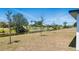 A spacious backyard featuring a canal view and ample green space for outdoor activities and relaxation at 220 Mark Twain Ln, Rotonda West, FL 33947