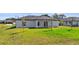 The backyard features a well-maintained lawn, creating a serene space for outdoor activities and relaxation at 220 Mark Twain Ln, Rotonda West, FL 33947