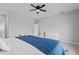 A well-lit bedroom includes a comfortable bed, a ceiling fan, desk, and white dresser at 220 Mark Twain Ln, Rotonda West, FL 33947