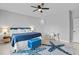 Stylish bedroom featuring blue accents, a comfortable bed, desk, and a decorative starfish rug at 220 Mark Twain Ln, Rotonda West, FL 33947