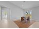 Bright dining area features wood table, 4 chairs, light tile floors, and sliding doors to the outdoor space at 220 Mark Twain Ln, Rotonda West, FL 33947