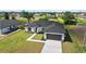 A charming single-Gathering home with a two-car garage and a well-manicured lawn near the canal at 220 Mark Twain Ln, Rotonda West, FL 33947