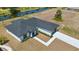 Aerial view of a white single-Gathering home with a dark roof, landscaping, and a canal at 220 Mark Twain Ln, Rotonda West, FL 33947