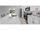 Beautiful kitchen features quartz countertop island with seating and stainless steel appliances at 220 Mark Twain Ln, Rotonda West, FL 33947