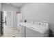 Modern laundry room with washer, dryer, sink, and ample storage cabinet at 220 Mark Twain Ln, Rotonda West, FL 33947