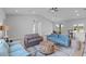 Open concept living room has lots of seating, a large rug, and access to the kitchen and dining area at 220 Mark Twain Ln, Rotonda West, FL 33947