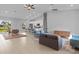 Open-concept living area with tile floors, high ceilings, ceiling fan and stylish furnishings at 220 Mark Twain Ln, Rotonda West, FL 33947