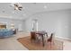 Spacious living space features neutral decor and tile flooring with a dining area with vaulted ceilings at 220 Mark Twain Ln, Rotonda West, FL 33947