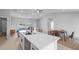 Open living space combines a modern kitchen with an island bar, dining area, and living room space at 220 Mark Twain Ln, Rotonda West, FL 33947
