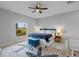 Comfortable main bedroom with a ceiling fan, carpet flooring, and an exterior view from a window at 220 Mark Twain Ln, Rotonda West, FL 33947