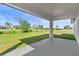 Relax on the patio with tranquil views of the lawn and canal at 220 Mark Twain Ln, Rotonda West, FL 33947