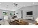 Bright, open-concept living space with tile floors, fan, and modern furnishings at 235 Albatross Rd, Rotonda West, FL 33947