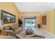 Open living room with access to a lanai and refreshing pool at 240 White Marsh Ln, Rotonda West, FL 33947