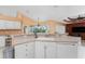 Kitchen with a large island, white cabinets, and a view to the backyard at 240 White Marsh Ln, Rotonda West, FL 33947