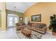 Spacious living room with two sofas, a coffee table, and a view of the pool at 240 White Marsh Ln, Rotonda West, FL 33947