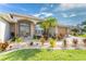 House exterior with landscaped yard and double doors at 240 White Marsh Ln, Rotonda West, FL 33947