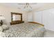 Bedroom with a large bed, dresser and ceiling fan at 240 White Marsh Ln, Rotonda West, FL 33947