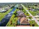 Aerial view of a house with a pool and canal-front lot at 240 White Marsh Ln, Rotonda West, FL 33947