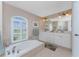 Large bathroom with double vanity, garden tub, and walk-in shower at 240 White Marsh Ln, Rotonda West, FL 33947