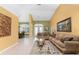 Bright living room with neutral tones, tile floors, and an open floor plan at 240 White Marsh Ln, Rotonda West, FL 33947