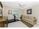 Bedroom with a treadmill, couch, and ceiling fan at 240 White Marsh Ln, Rotonda West, FL 33947