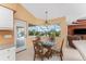 Kitchen breakfast nook with glass table and chairs, overlooking the pool at 240 White Marsh Ln, Rotonda West, FL 33947