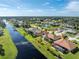 Aerial view of house and neighborhood near canal at 240 White Marsh Ln, Rotonda West, FL 33947