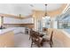 Bright breakfast nook with glass table and chairs near the kitchen at 240 White Marsh Ln, Rotonda West, FL 33947