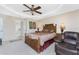 Spacious bedroom with a ceiling fan, large bed, and sitting area at 240 White Marsh Ln, Rotonda West, FL 33947