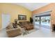Living room with sliding doors that lead to a beautiful view of the pool at 240 White Marsh Ln, Rotonda West, FL 33947