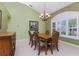 Elegant dining room with a wooden table, chairs, and a chandelier at 240 White Marsh Ln, Rotonda West, FL 33947