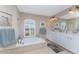 Large bathroom with double vanity, garden tub, and walk-in shower at 240 White Marsh Ln, Rotonda West, FL 33947