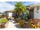 Well-maintained home with attractive landscaping and a paved walkway at 240 White Marsh Ln, Rotonda West, FL 33947
