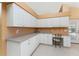 Spacious kitchen with white cabinets and built-in desk area at 240 White Marsh Ln, Rotonda West, FL 33947