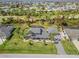 Aerial view of a single Gathering home with lush landscaping at 61 Pinehurst Pl, Rotonda West, FL 33947