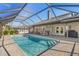 Inviting screened pool and patio area with outdoor kitchen at 61 Pinehurst Pl, Rotonda West, FL 33947