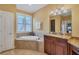 Bathroom featuring a soaking tub, granite countertops and wood cabinets at 2517 Rio Grande Dr, Punta Gorda, FL 33950
